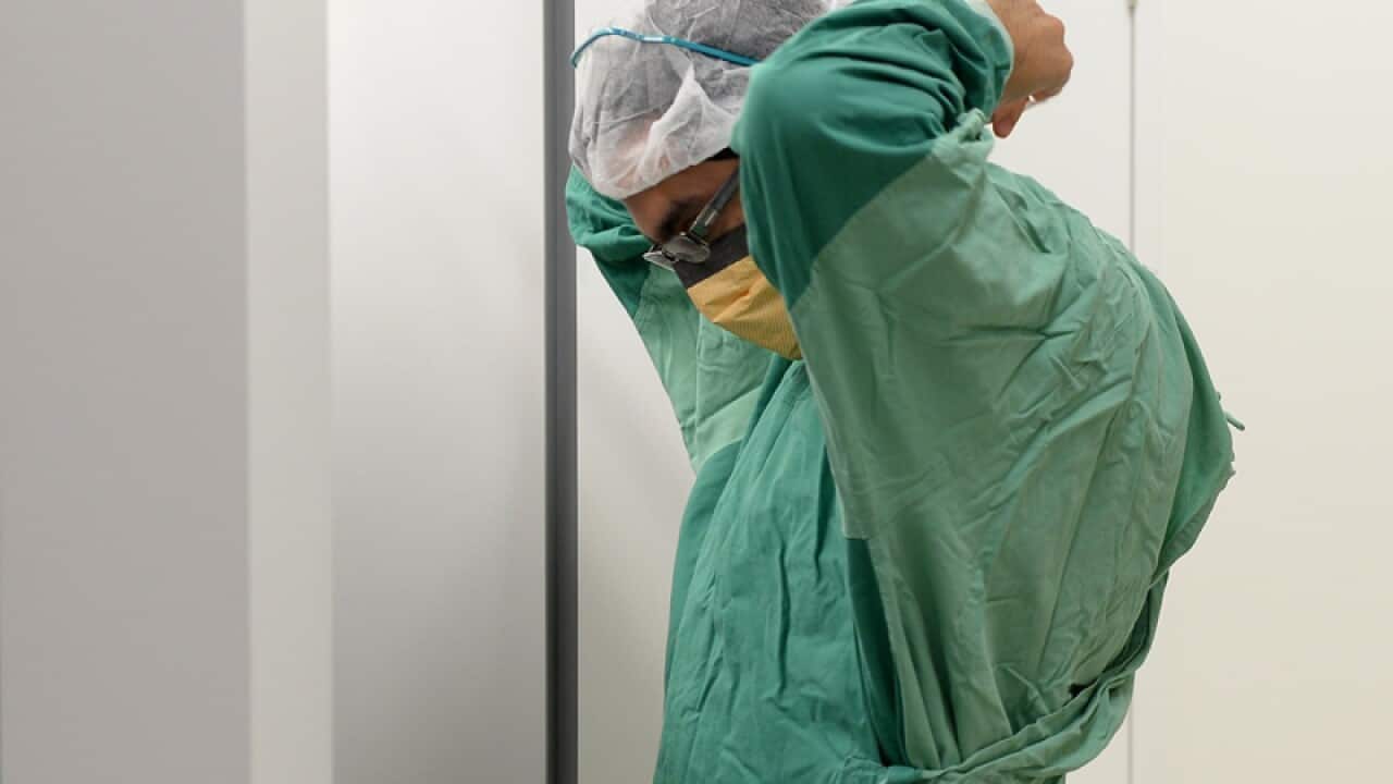 A surgeon prepares for theatre