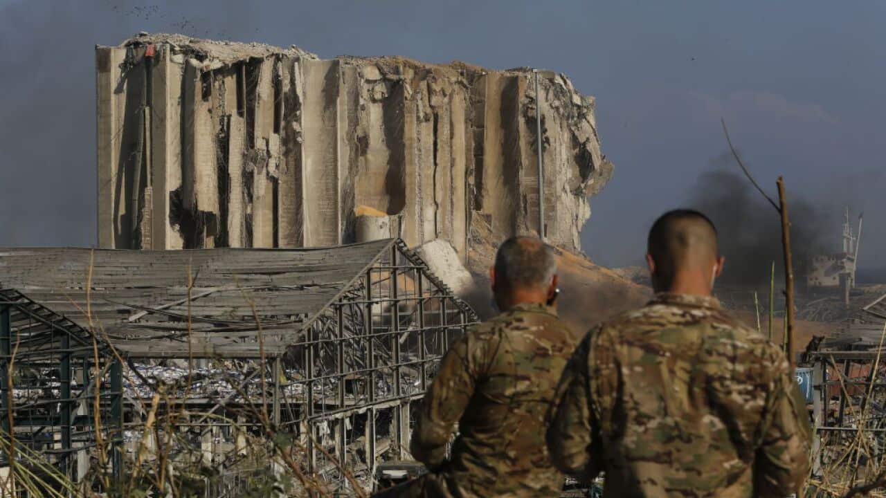 Military personnel survey wrecked buildings in the Beirut port