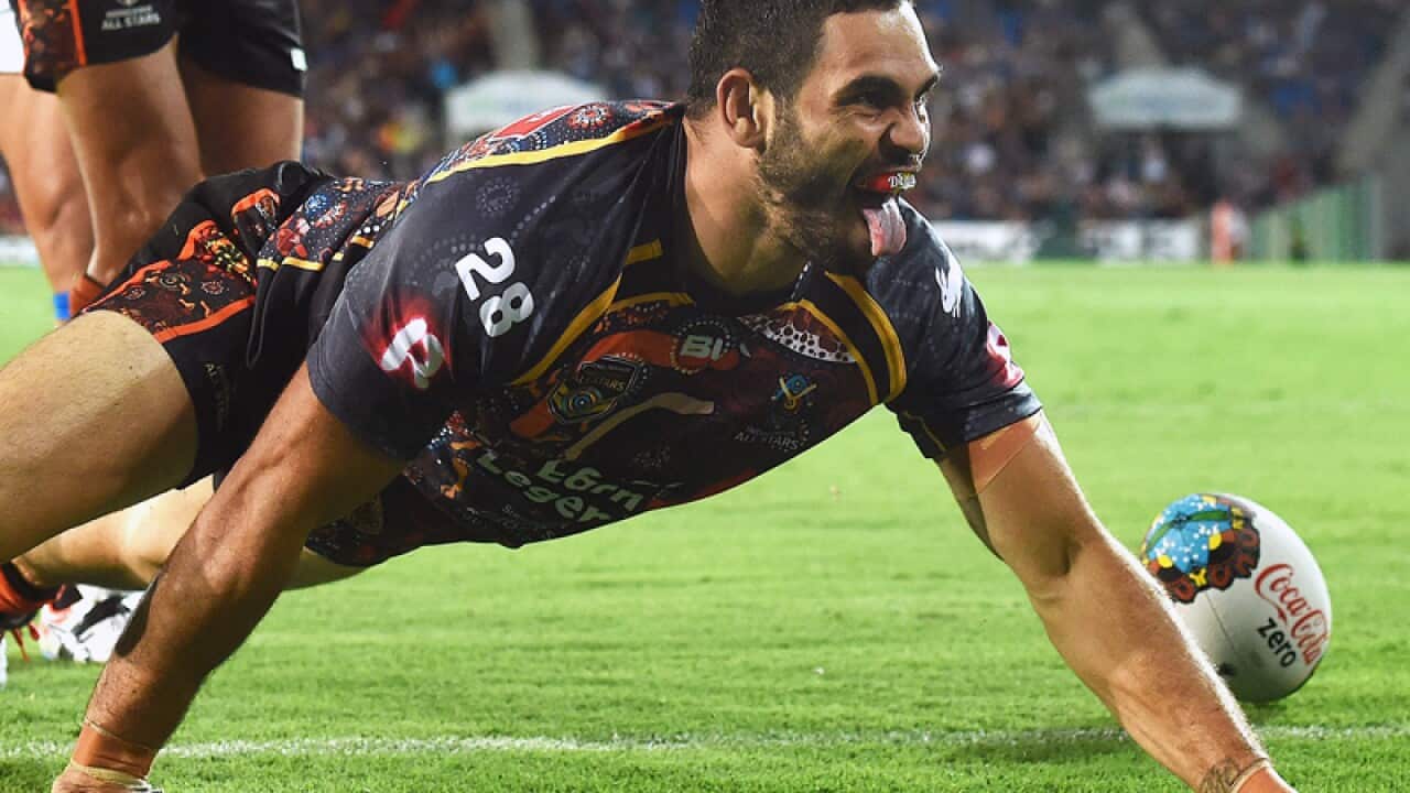 Greg Inglis celebrates with a goanna crawl