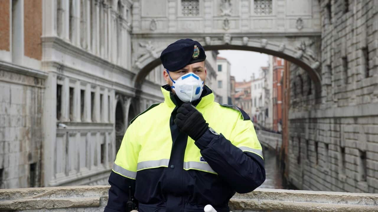 A police officer wears a protective face mask during the Carnival in Venice, Italy
