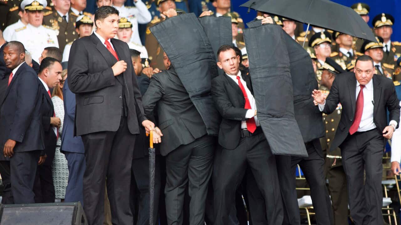 Security personnel surround Venezuela's President Nicolas Maduro.