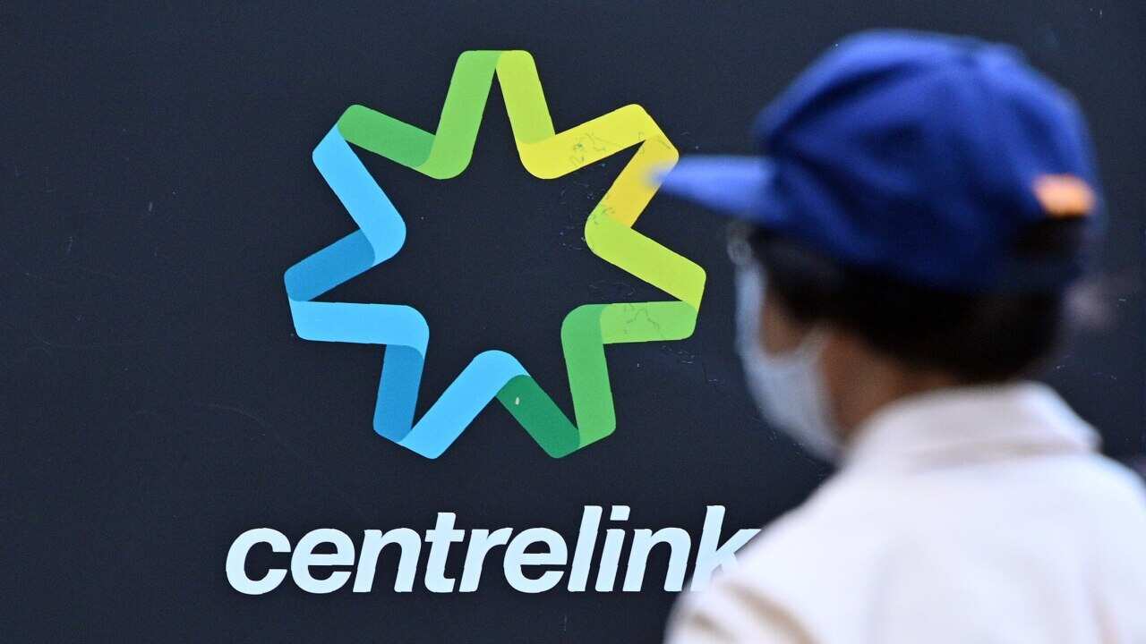 Person standing in front of centrelink sign