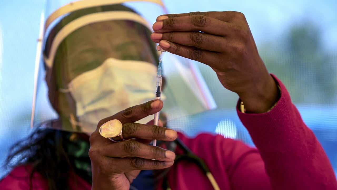 A health worker prepares a dose of vaccine at a mass vaccination centre in South Africa