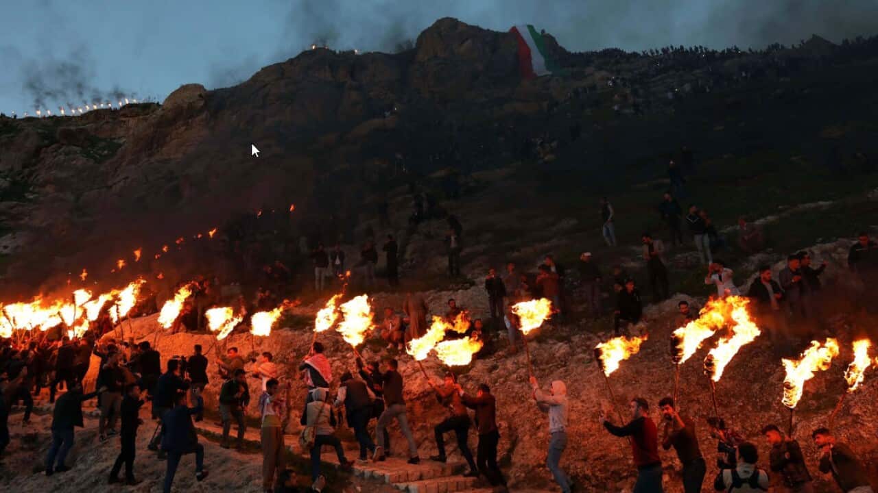 Kurds holding lit torches in Akre