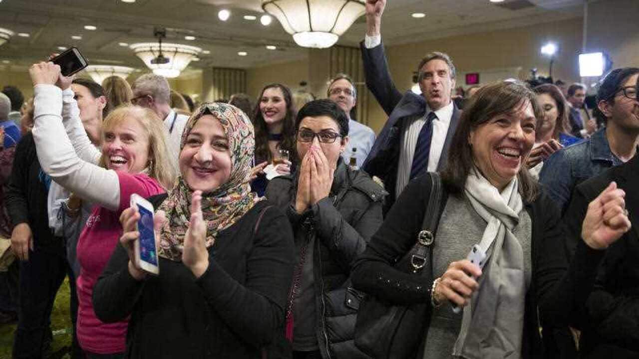 Supporters cheer as they watch returns at an election night party for Democrat congressional candidate Jennifer Wexton.