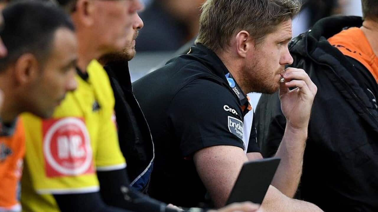 Chris Lawrence watches play from the Tigers' bench