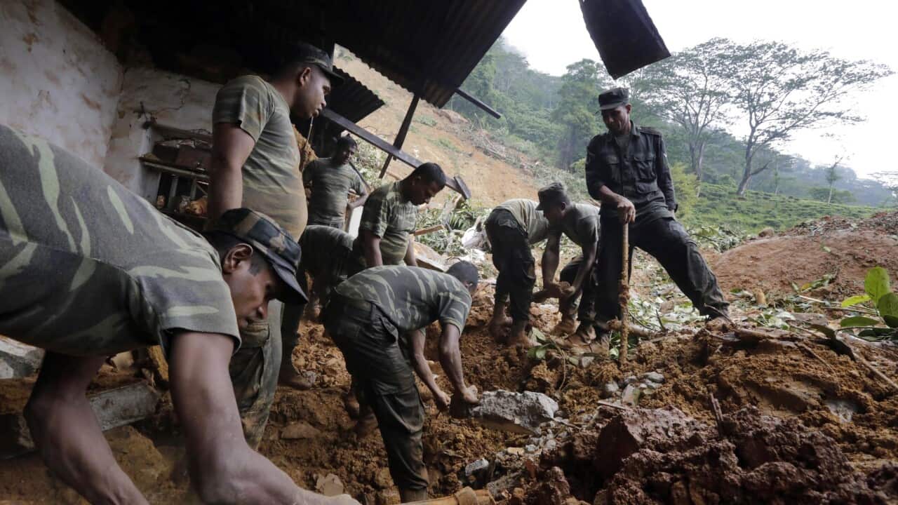 Sri Lanka Armed Forces personnel engage in rescue operations at the landslide area at Kalupahanawatte in Bulathkohupitiya