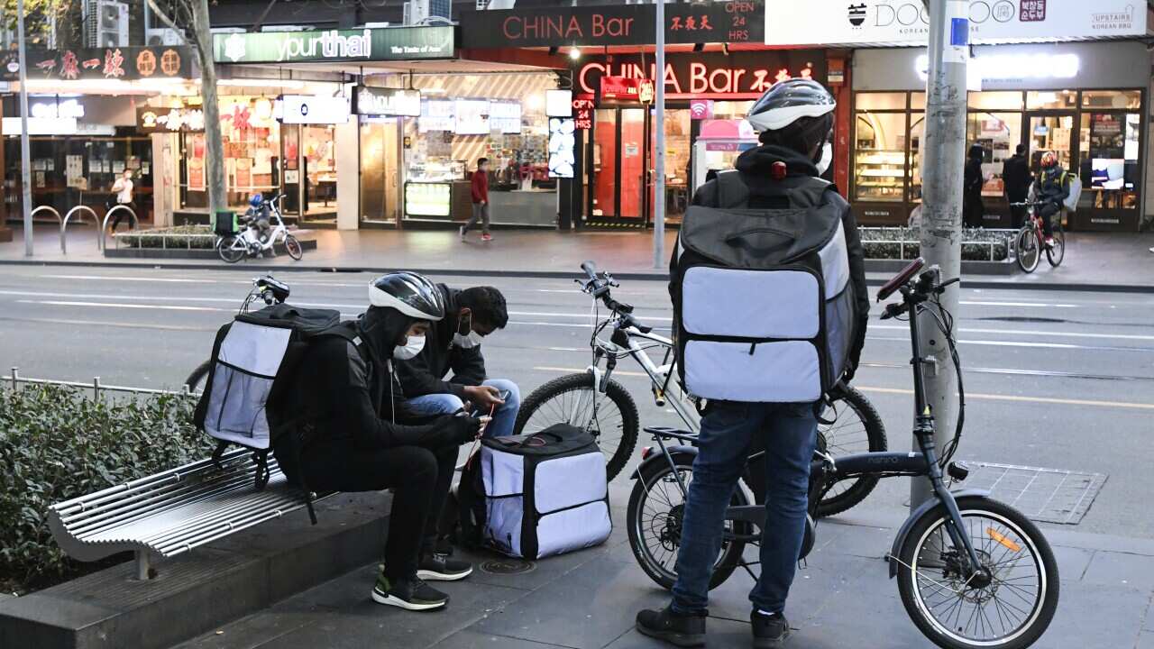 Delivery riders are seen in the Melbourne CBD.