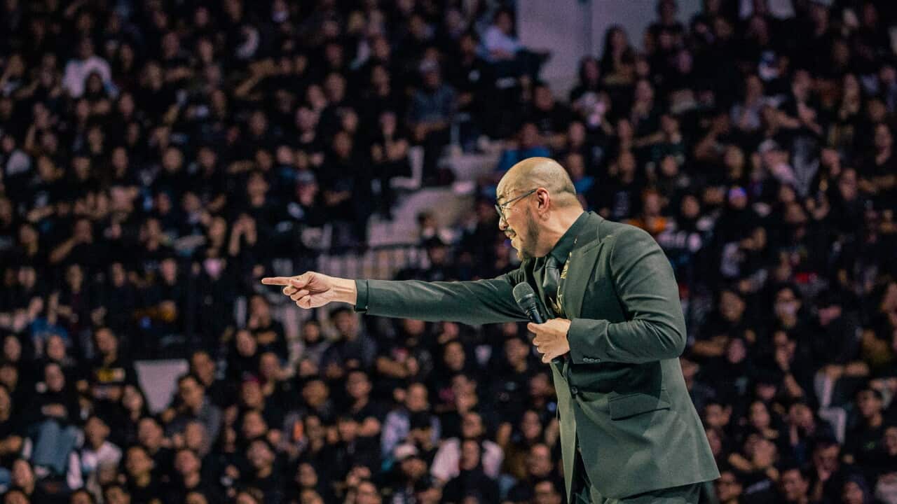 Indonesian comedian Pandji Pragiwaksono on stage during a stand up comedy performance.