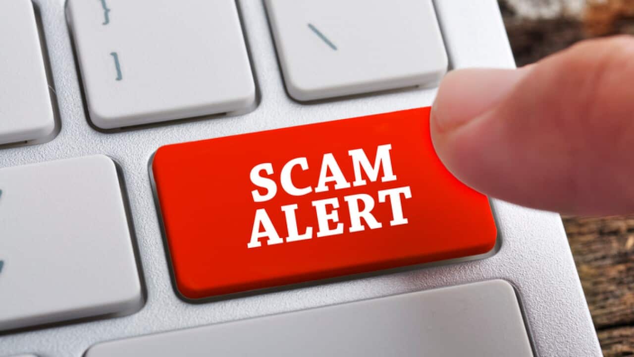 Finger at "SCAM ALERT" On Keyboard Button