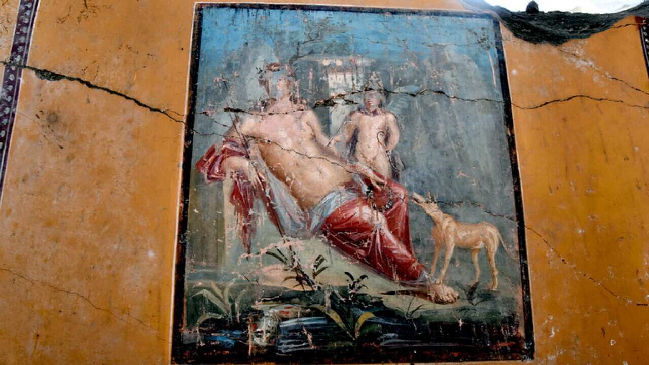 Archaeologists at Pompeii, South Italy on February 14, 2019 present a stunning fresco depicting Narcissus