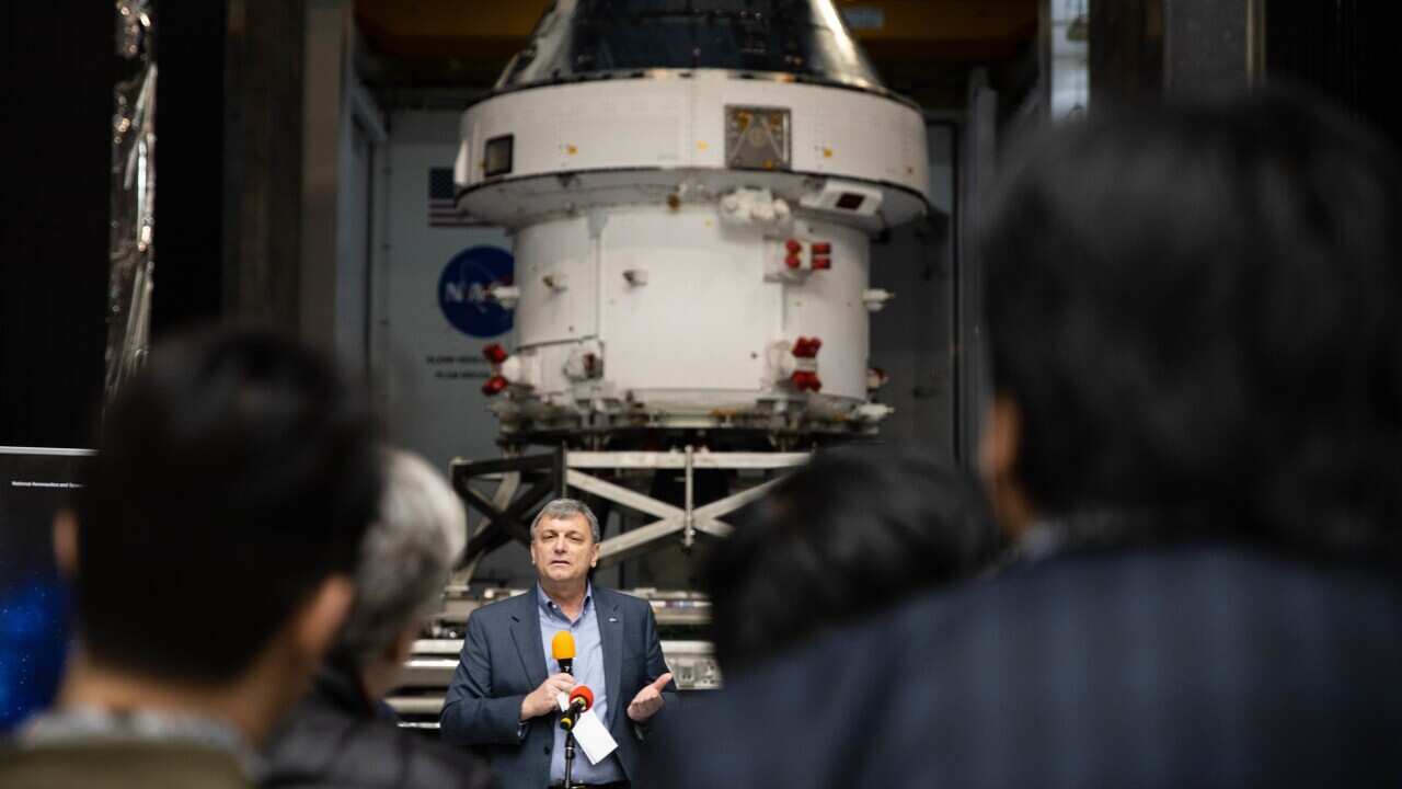 Spectators are seen at the unveiling of the Orion Space Craft.