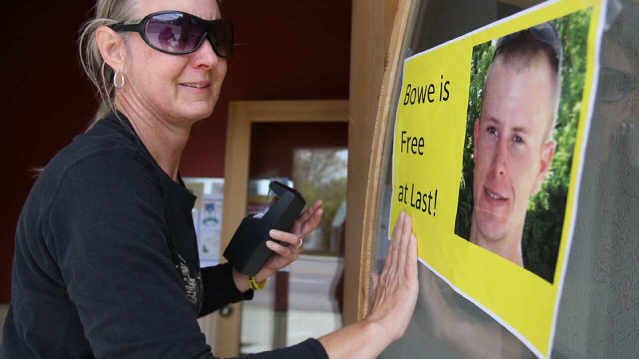 A woman hands a sign celebrating Bowe Bergdahl's release