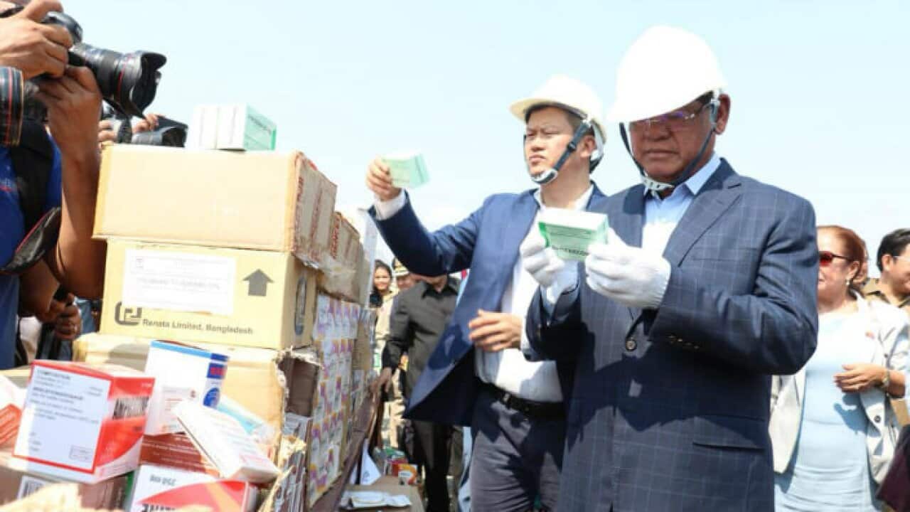 Cambodia Interior Minister Sar Kheng is checking the fake products