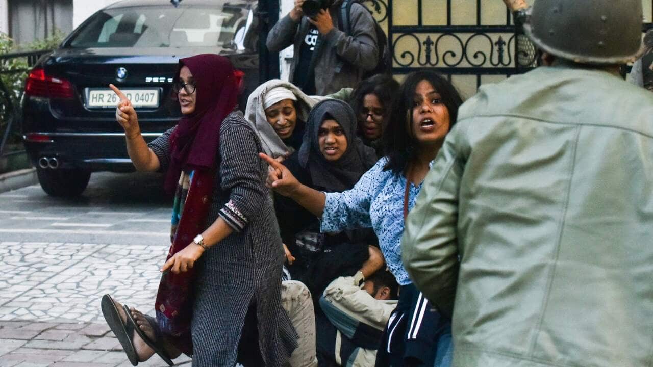 Ayesha Renna (C) and other protesters argue with policemen during a demonstration against the Indian government's Citizenship Amendment Bill (CAB) in New Delhi.