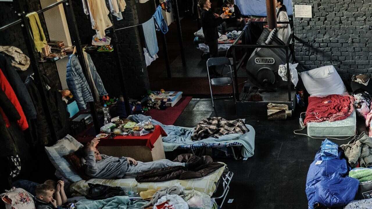 People seen at a gym converted for accommodation for refugees from the Russian military aggression in Ukraine. (Photo by Mykola Tys / SOPA Images/Sipa USA)