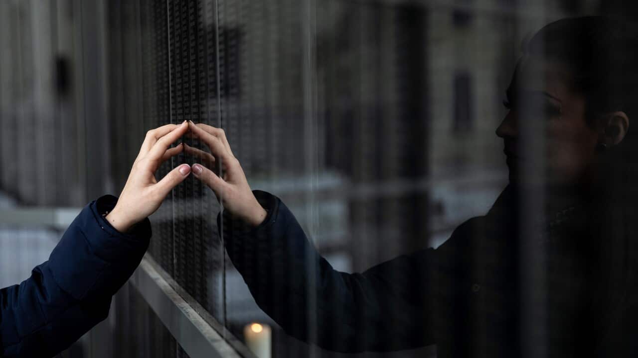 A visitor reads names on the victims' wall in the Holocaust Memorial Center in Budapest, Hungary.