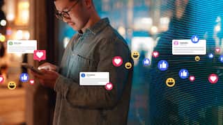 Young Asian man connecting with social media network with smartphone