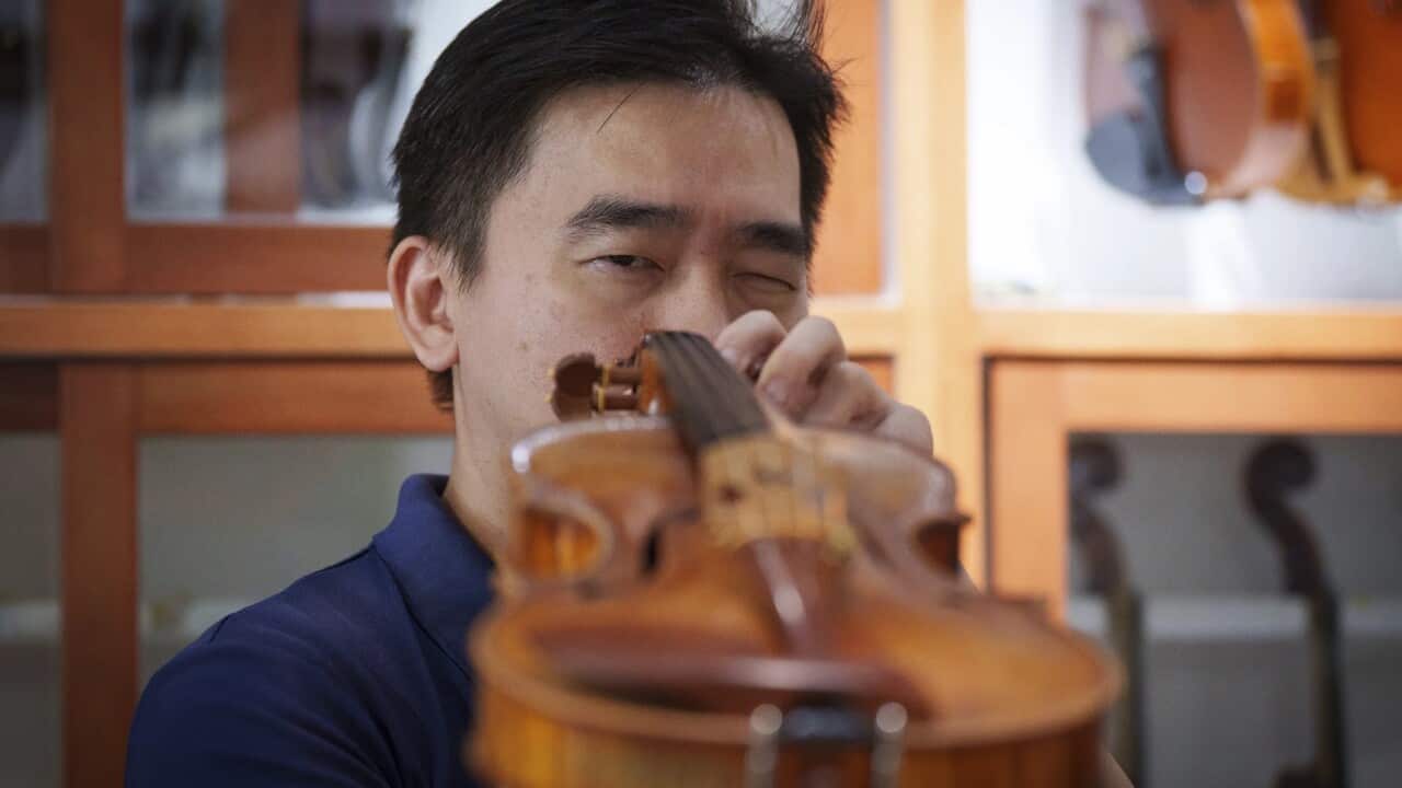 Malaysian luthier Tan Chin Sang checks a handcrafted violin at his workshop on the outskirts of Kuala Lumpur, Malaysia (AP Photo-Vincent Thian).jpg