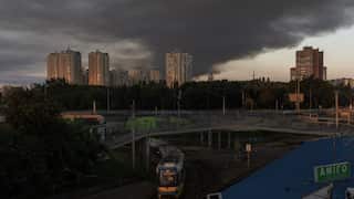 Smoke rises over apartment buildings.
