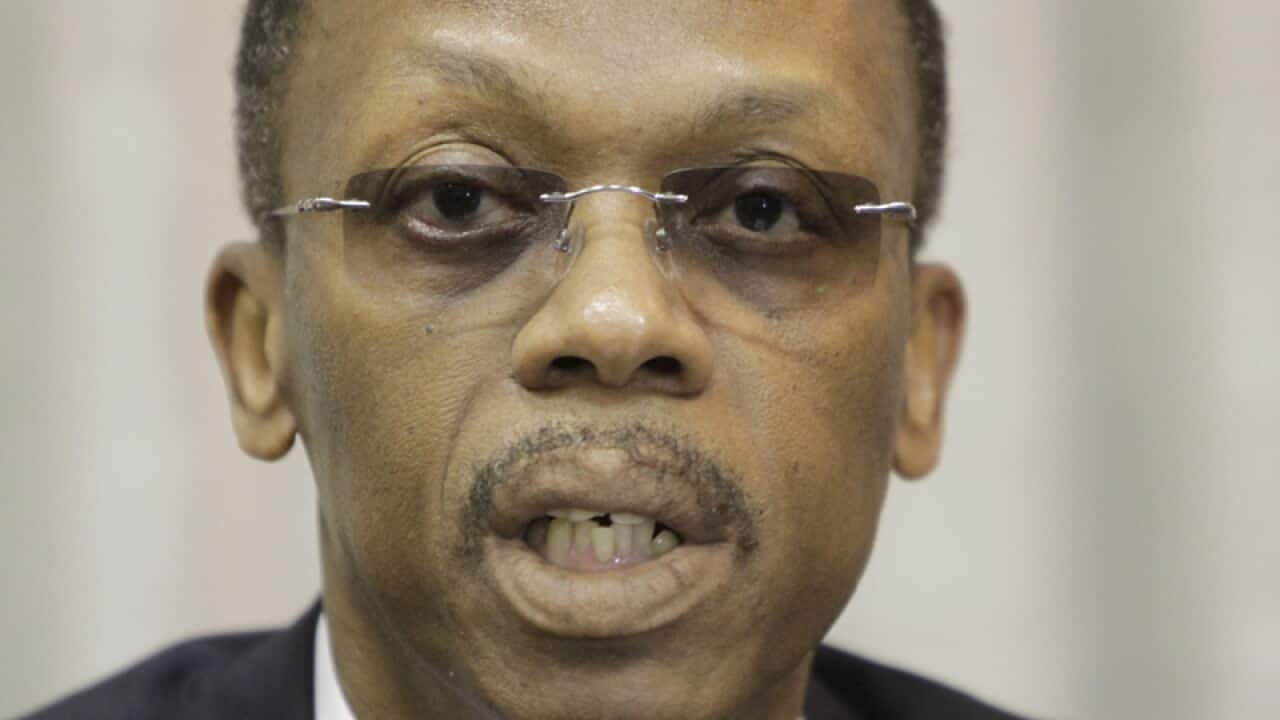Jean-Bertrand Aristide speaks at a press conference.