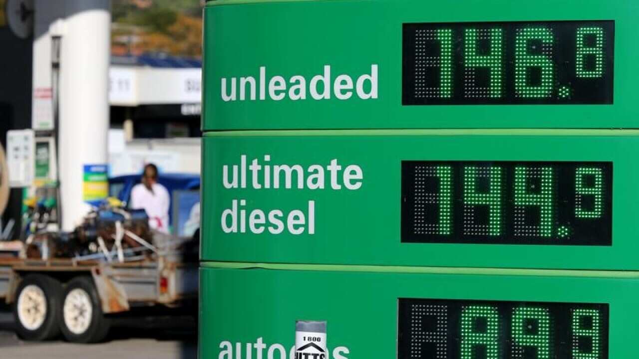 An electronic sign displays petrol prices at a service station
