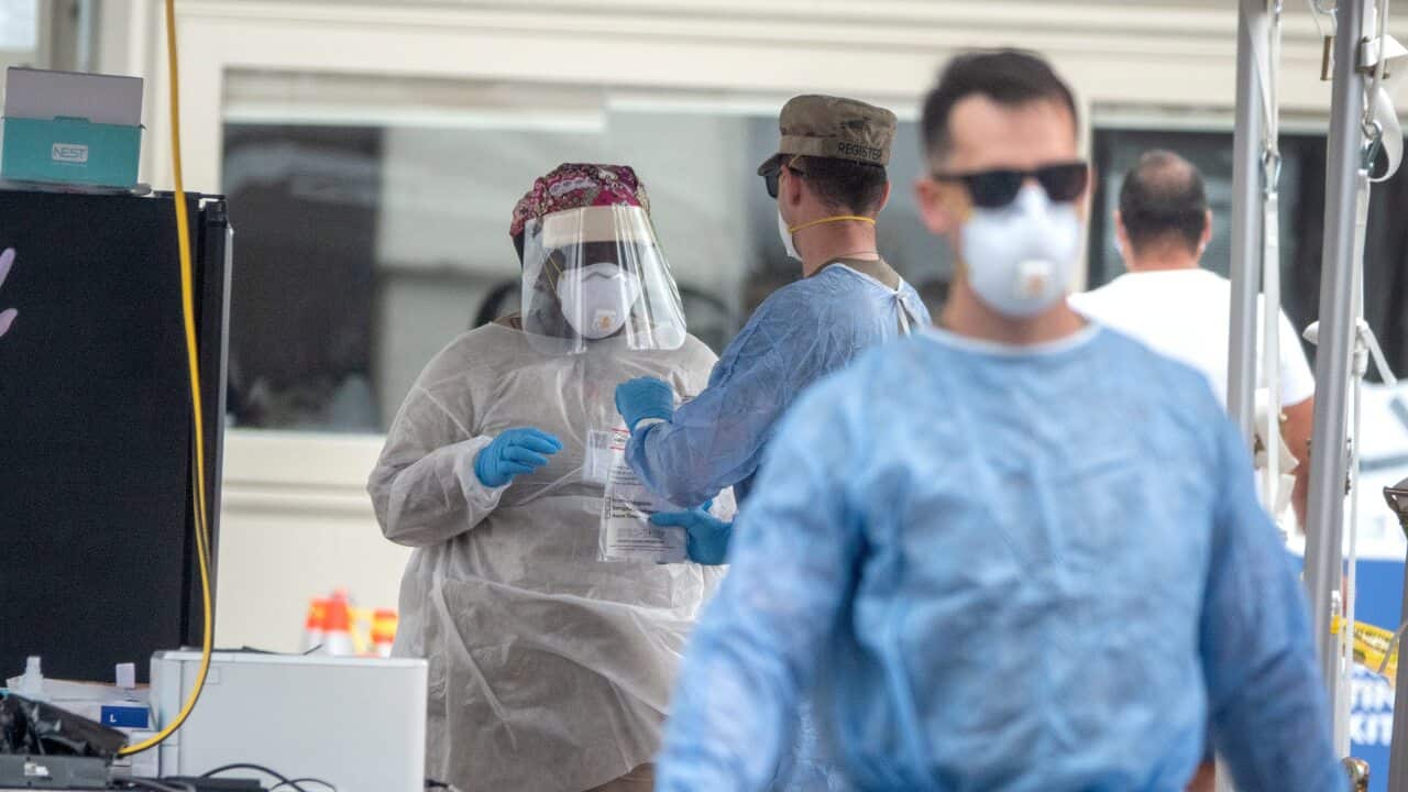 Healthcare workers collect tests at the Miami Beach Convention Center in Miami Beach, Florida, 23 July 2020