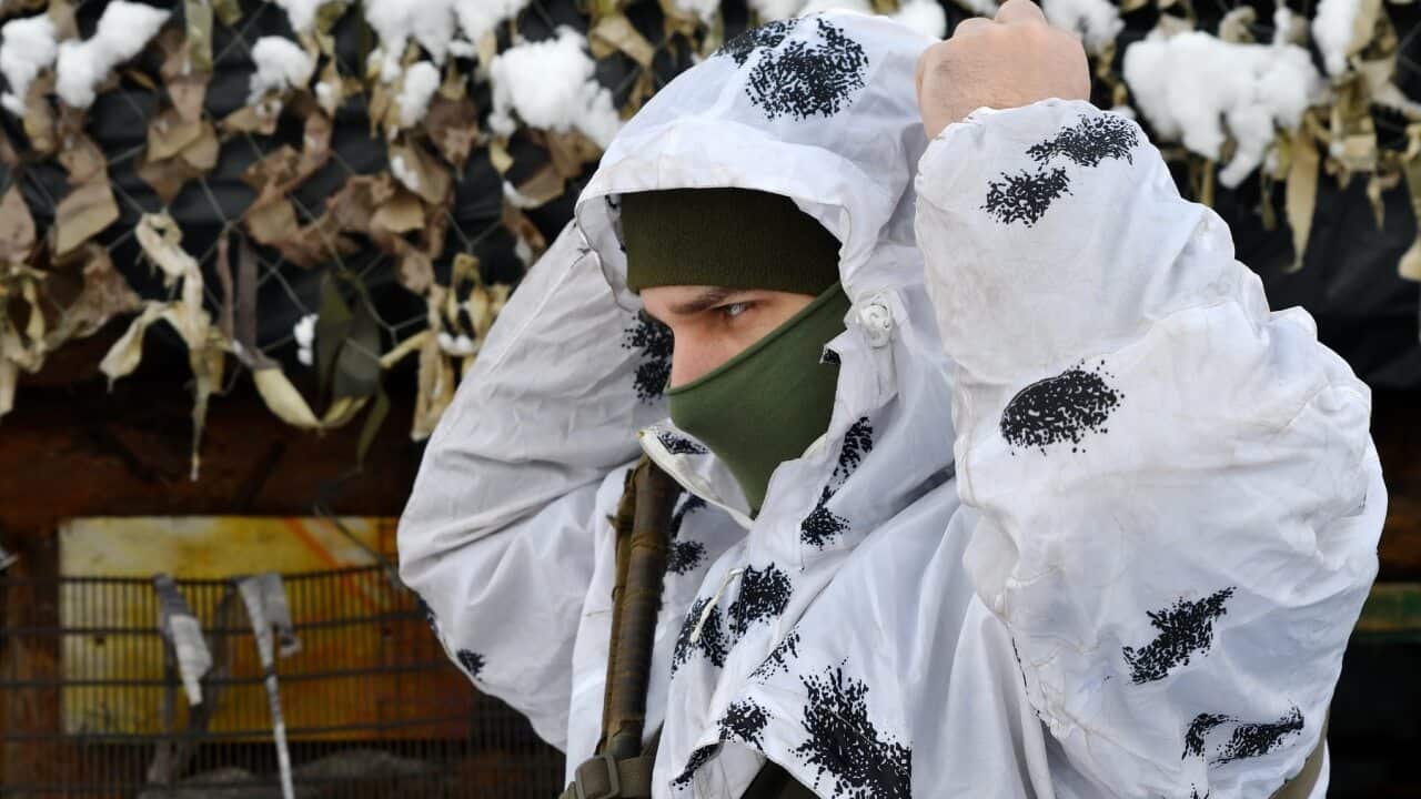 A Ukrainian soldier dons winter camouflage gear on the eastern border with Russia