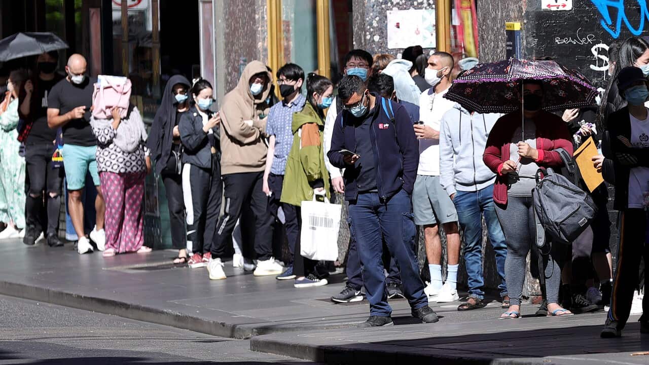 People are seen in a queue at the Russell Street testing clinic in Melbourne, Monday, December 20, 2021