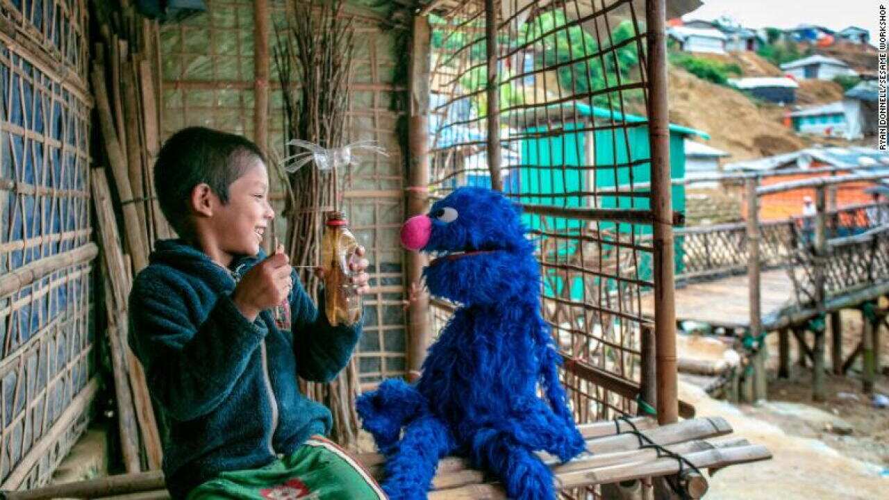 A refugee boy in Bangladesh's refugee camp Cox's Bazaar and a character from Sesame Street