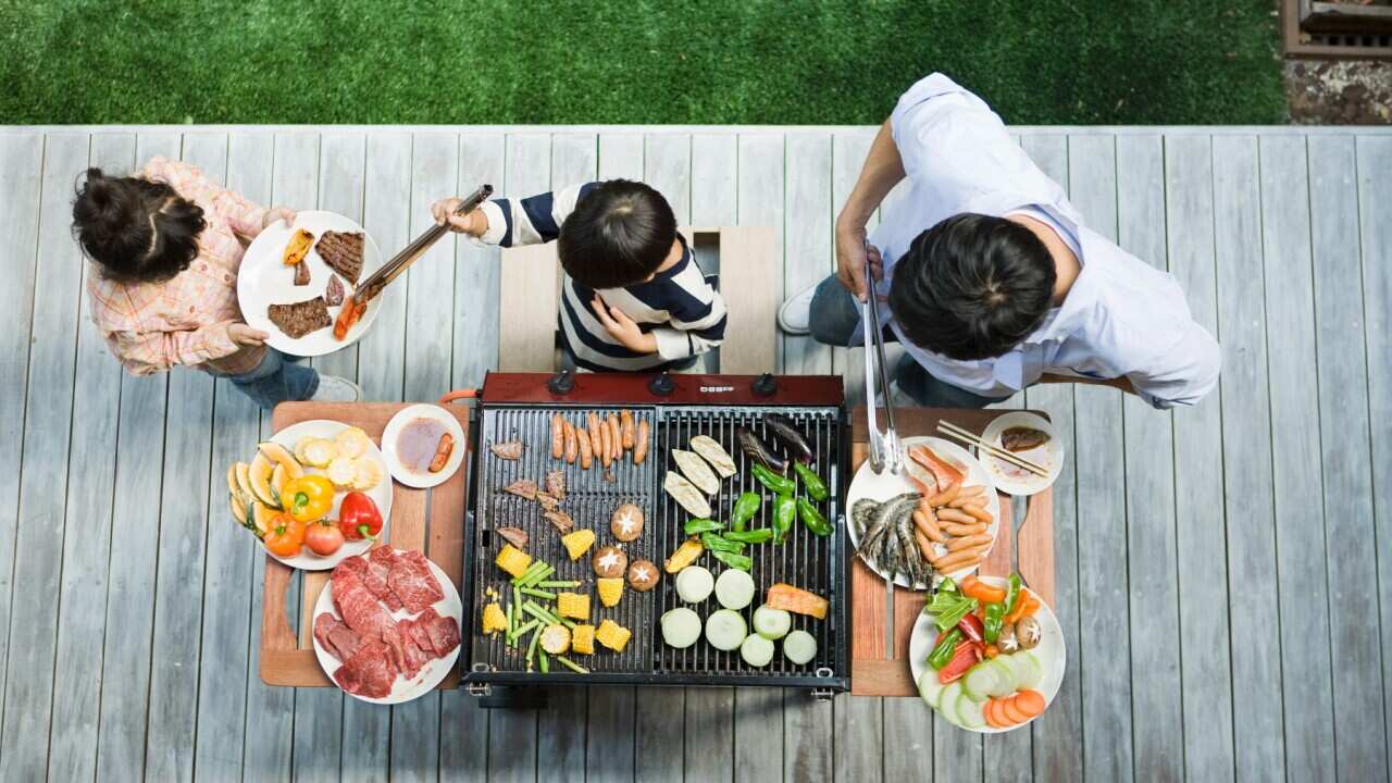 man-and-boy-cooking-barbecue-for-family