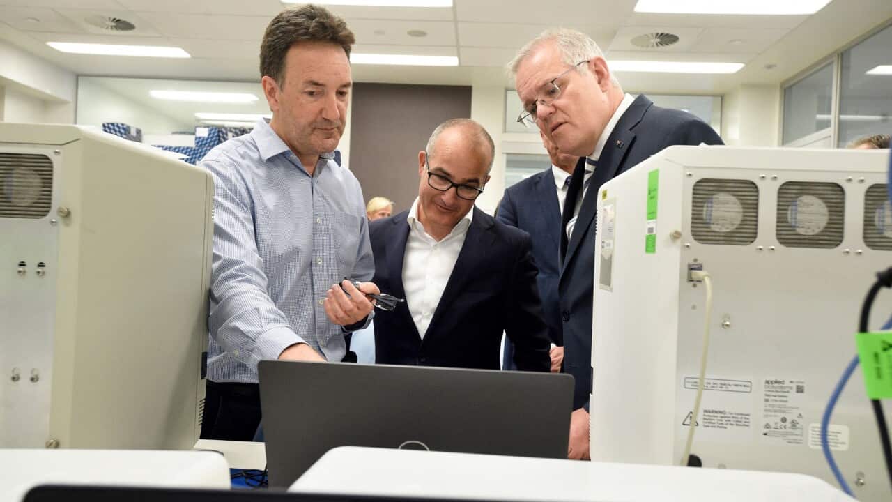 Australian Prime Minister Scott Morrison (R) and Victorian Deputy Premier James Merlino (C) tour The Peter Doherty Institute for Infection and Immunity in Melbourne with Dr Julian Druce