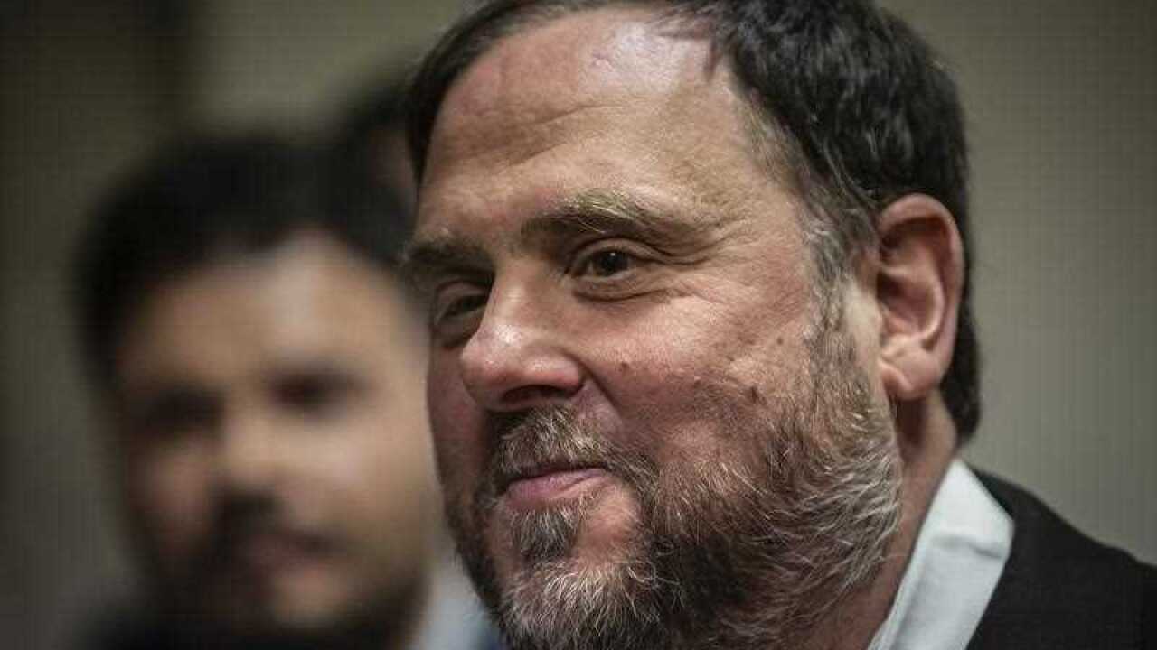 The leader of the Catalonian ERC party Oriol Junqueras leaves after collecting his credentials at the Spanish parliament.
