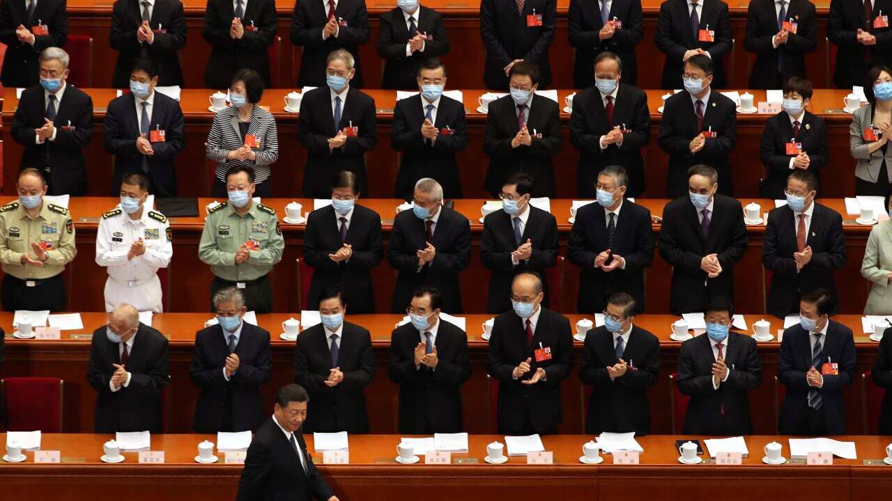 Delegates applaud as Chinese President Xi Jinping arrives for the opening session of China's National People's Congress (NPC).