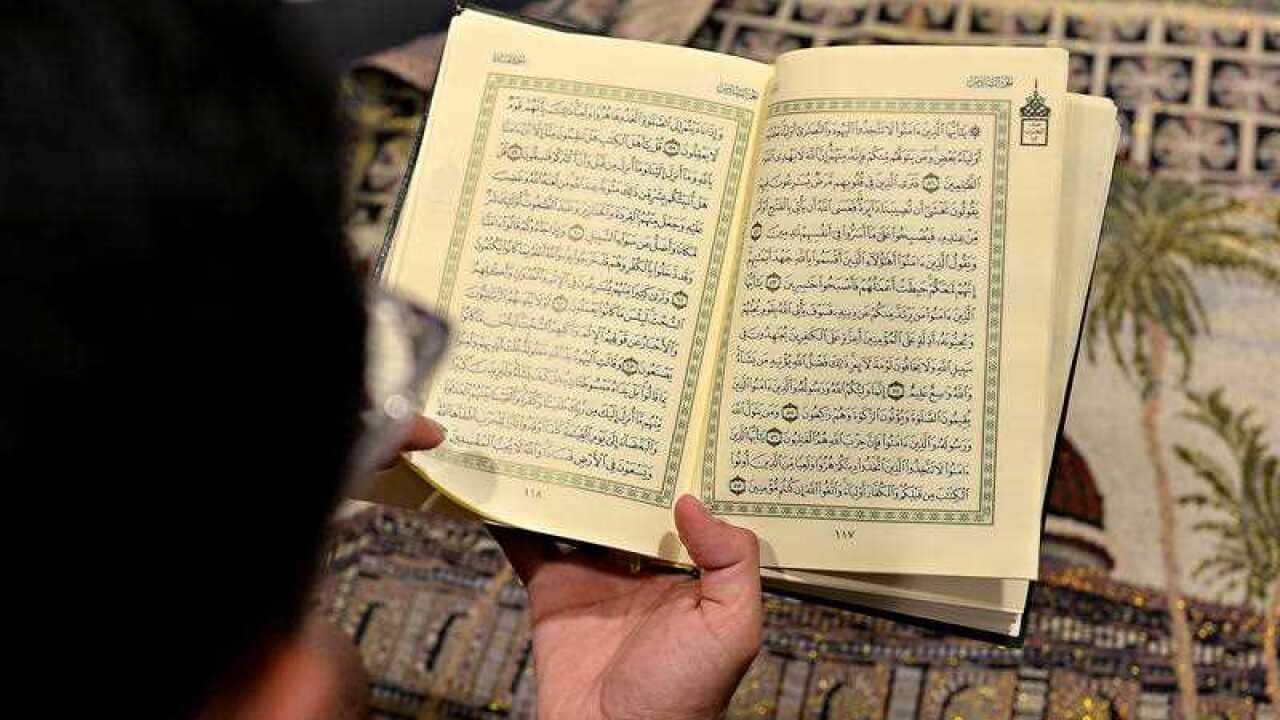 Student Abdulrahman Alsulaim looking through the Qur'an