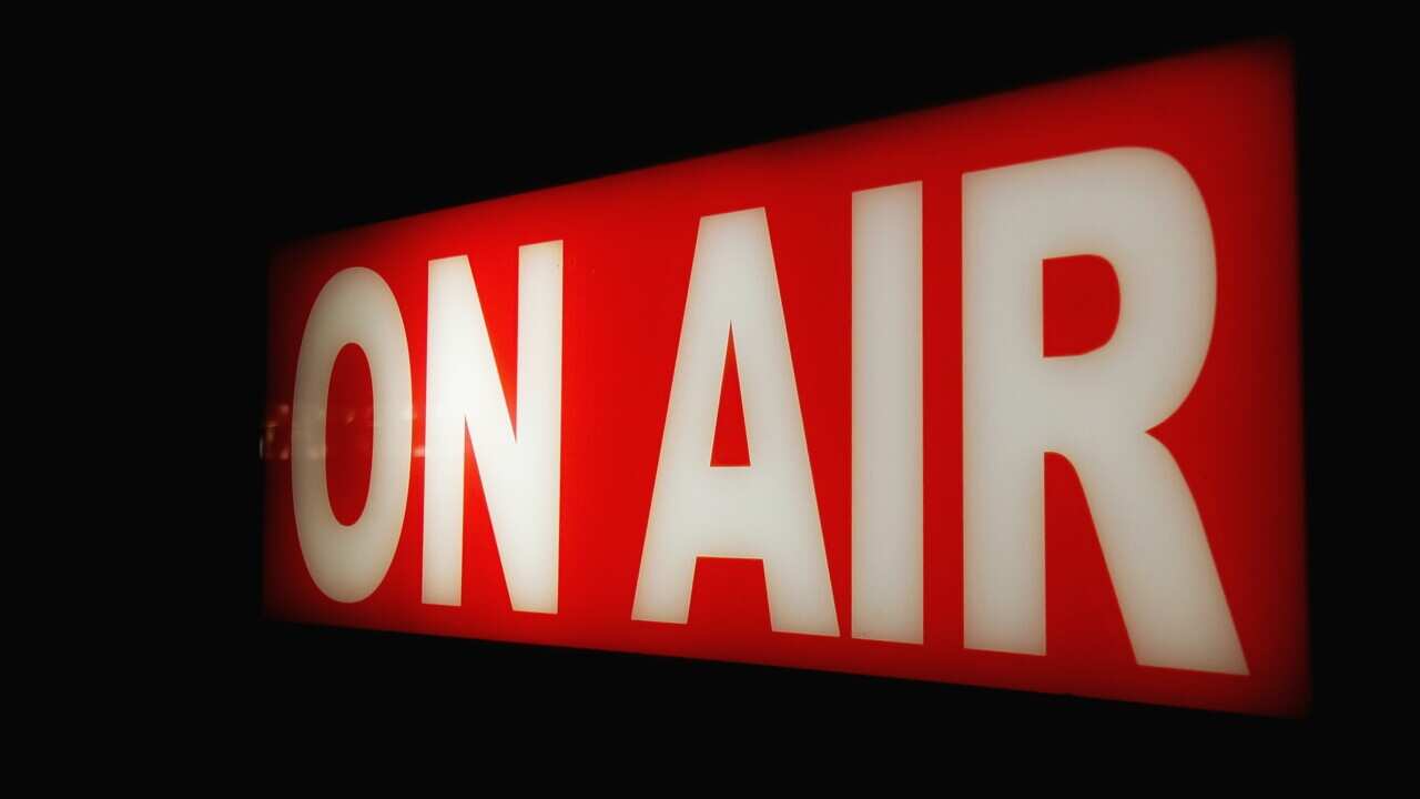 Close-Up Of Illuminated On Air Sign Against Black Background