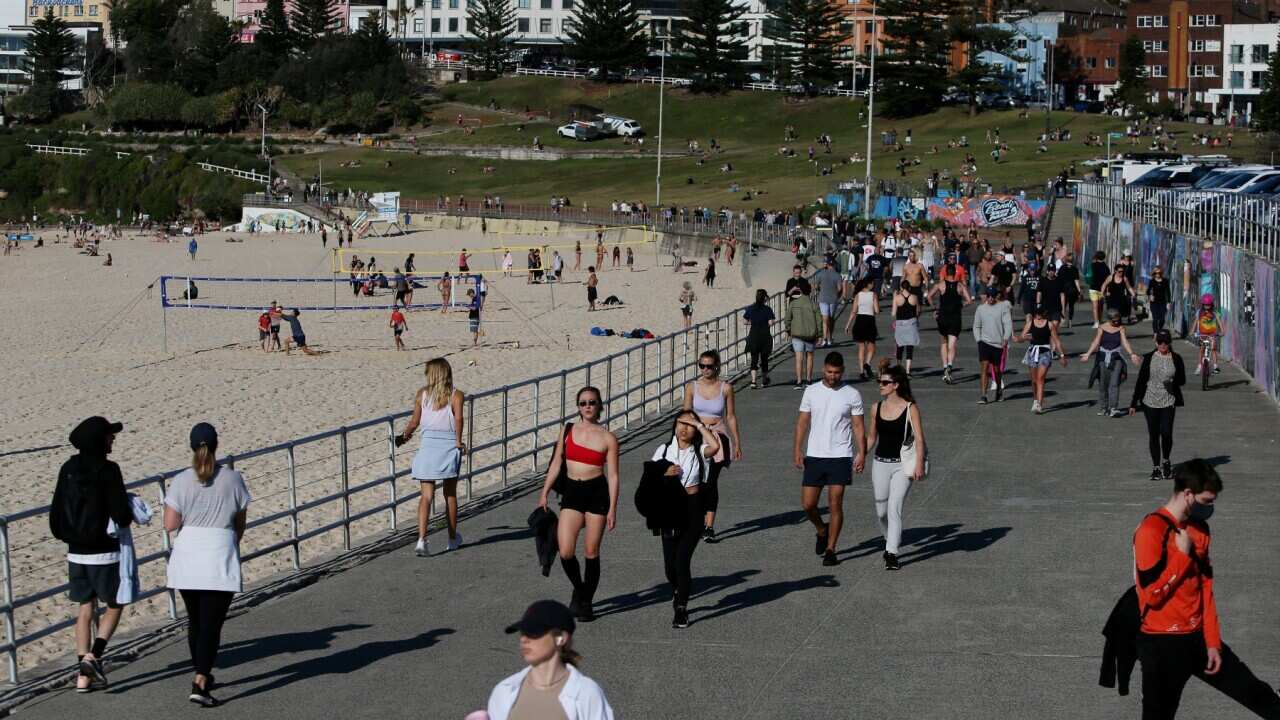 People exercising along the boardwalk at Bondi Beach in Sydney