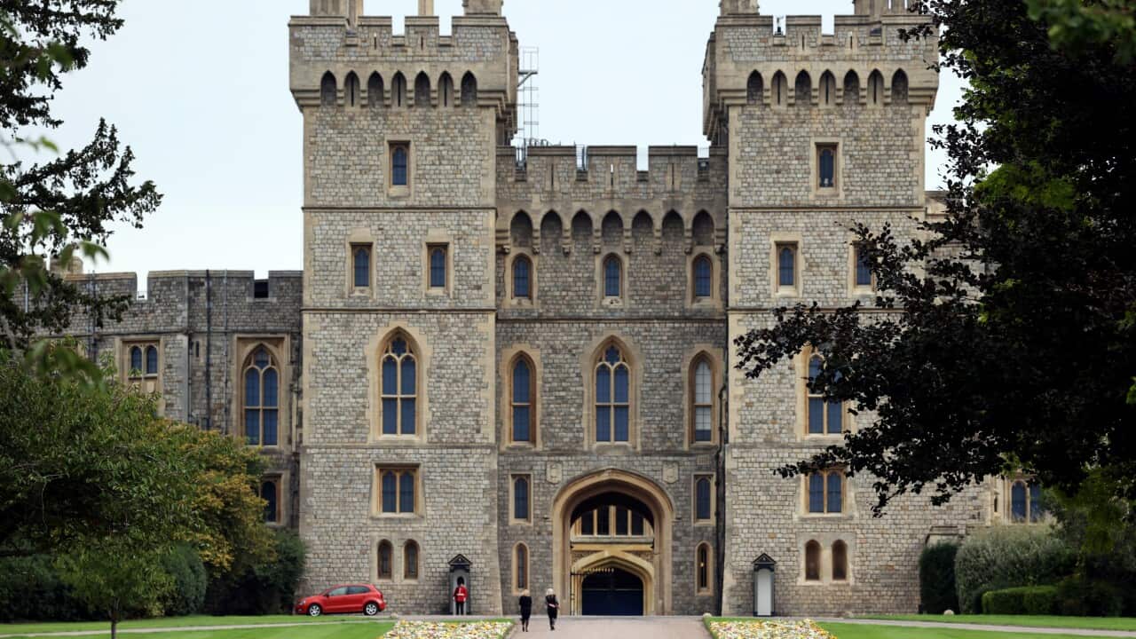 Two people outside Windsor Castle
