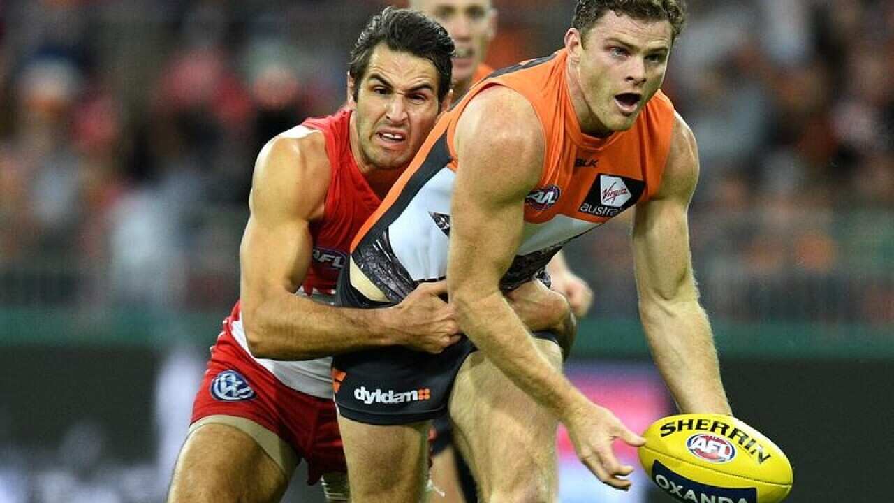 Heath Shaw of the Giants hand passes the ball.