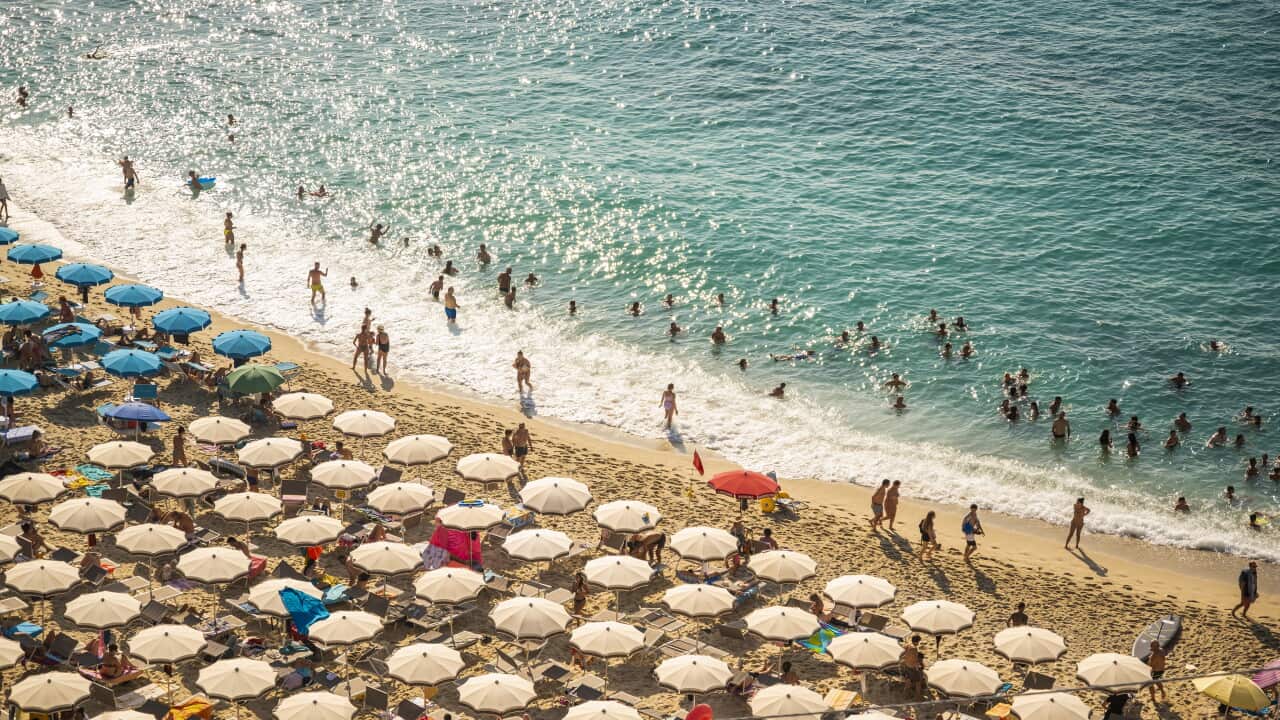 Tourists sunbathing in Tropea, Calabria, Italy