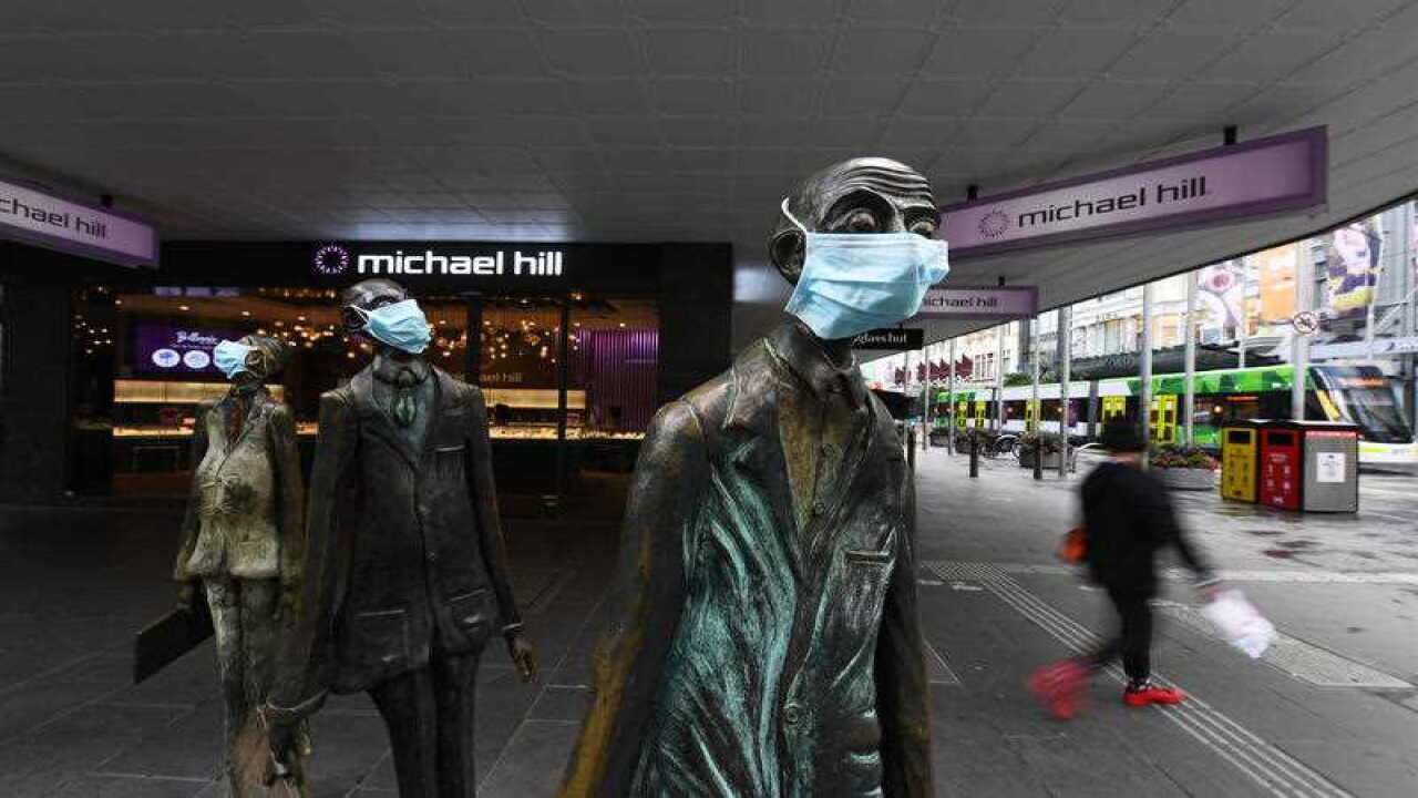 Masks are seen on a statue along Swanston street in Melbourne, Monday, July 20, 2020.