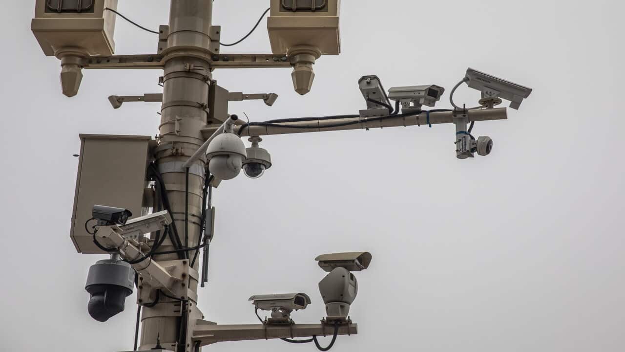 A lamp post hosting surveillance cameras near Tiananmen Square in Beijing.