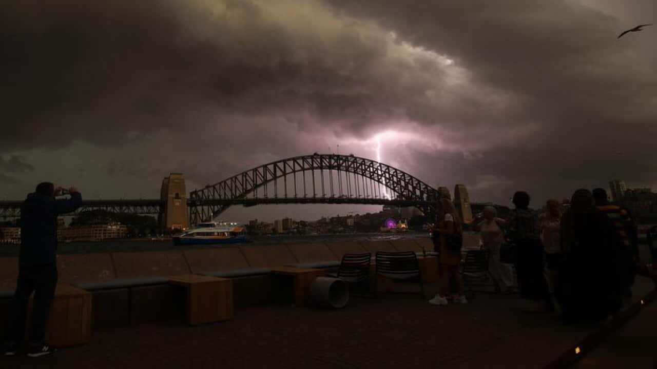 A lightning bolt strikes as a storm cell is seen above the Sydney Harbour Bridge in Sydney