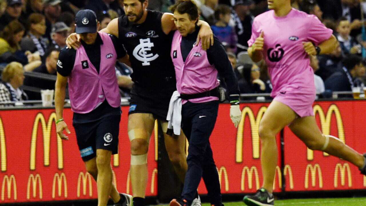 Levi Casboult of the Carlton Blues is taken off injured