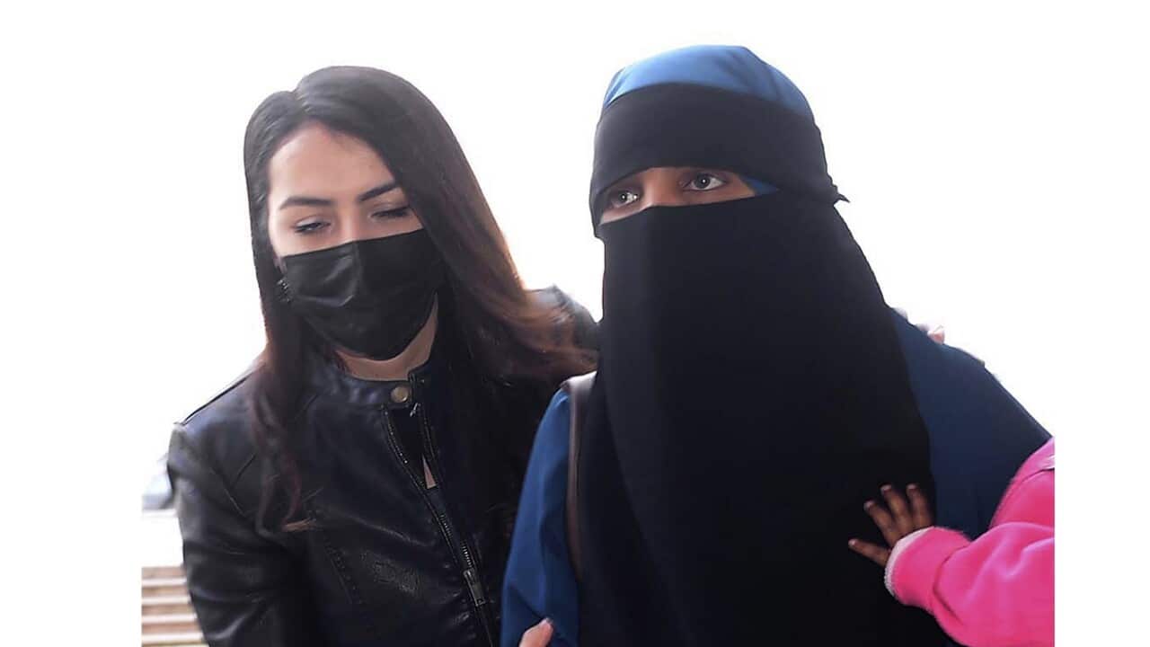 The woman believed to be Suhayra Aden is escorted by a Turkish police officer