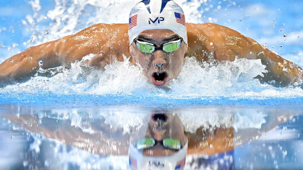 Michael Phelps swims in the men's 100-meter butterfly