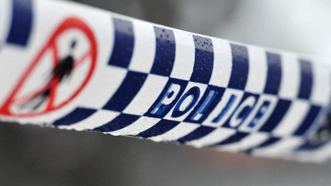 Police tape restricts access to a crime scene