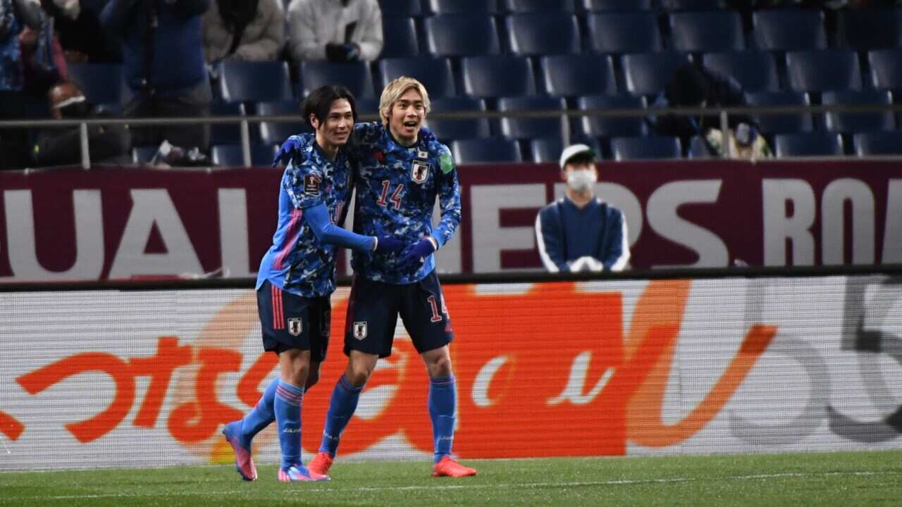 Takumi Minamino of Japan celebrates the opener with Jyunya Ito of Japan during the FIFA World Cup Asian Qualifier Final Round Group B match between Japan and Saudi Arabia at Saitama Stadium on February 1, 2022 in Saitama, Japan