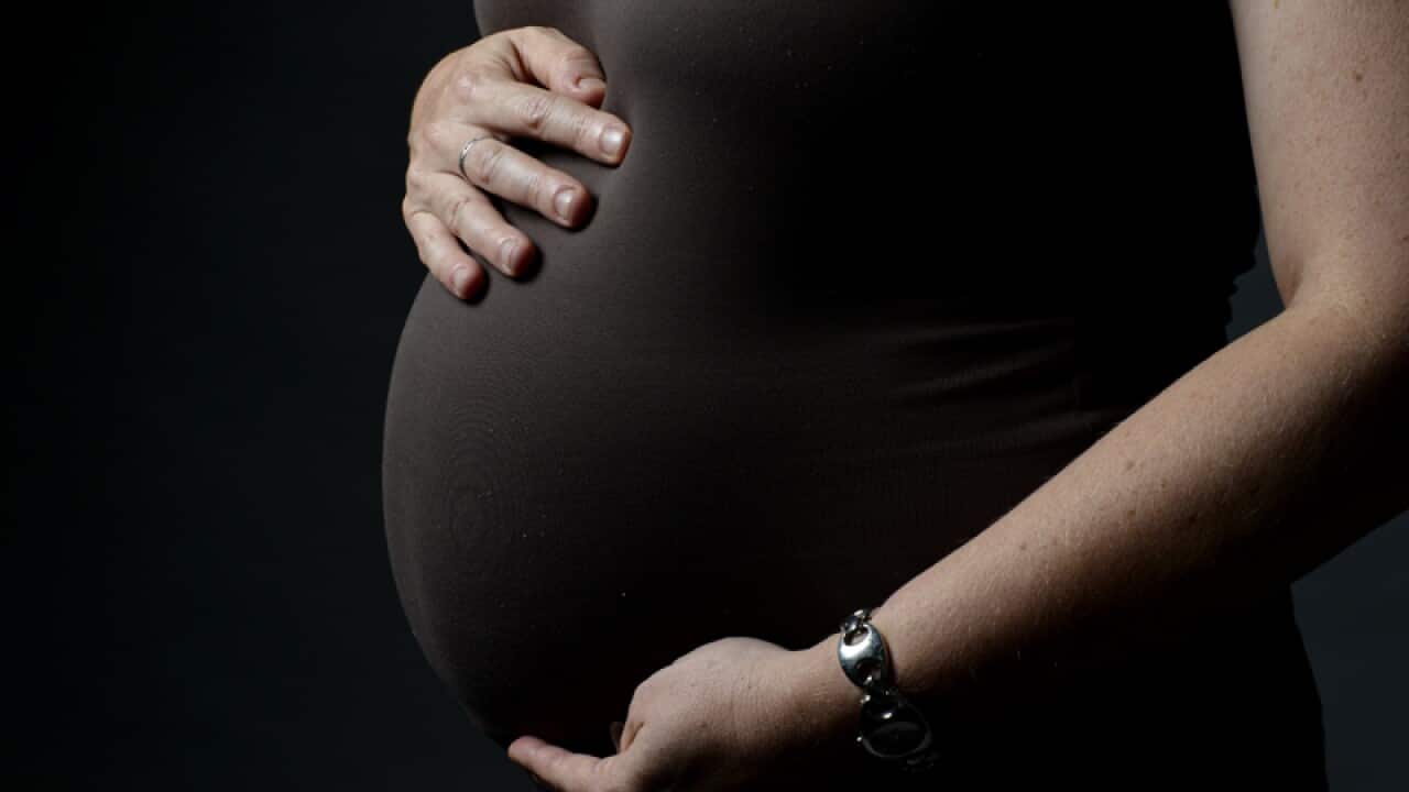 A woman eight months into her pregnancy