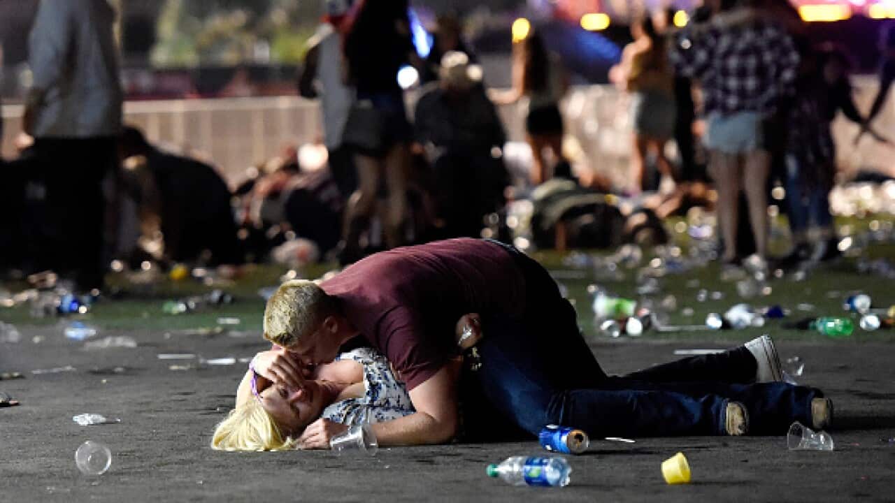 The haunting photo of a young man covering a woman from bullets during the Las Vegas massacre.